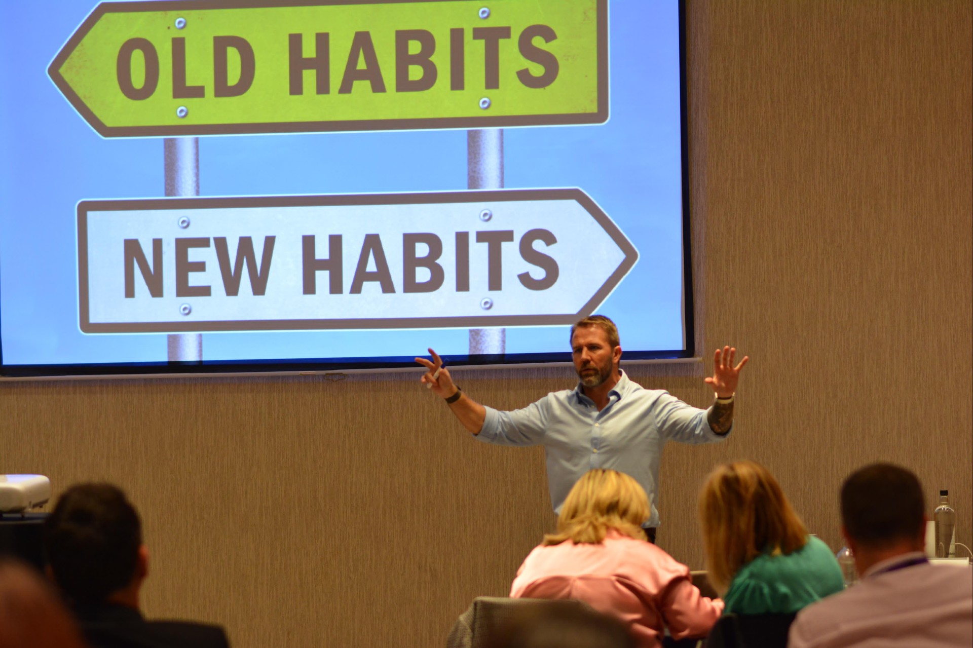 Lindsay Bruce speaking on stage to an audience